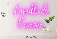 a pink neon sign with the words famille de l'anou on it