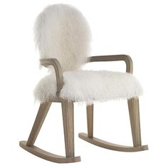 a wooden rocking chair with white fur on it's back and arms, in front of a white background