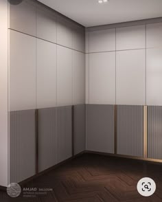 an empty room with wooden floors and white walls, next to a wall divider