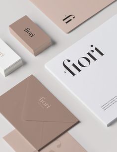 the brand identity is laid out on top of each other, including an envelope and business cards