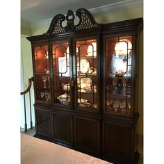 an antique china cabinet with glass doors