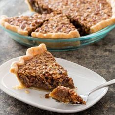 a slice of pecan pie on a plate with a fork