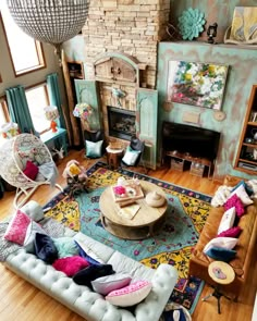 a living room filled with furniture and a fire place in the middle of a room