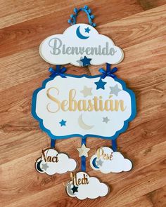 a wooden sign that says sebastian on it with stars and clouds around it