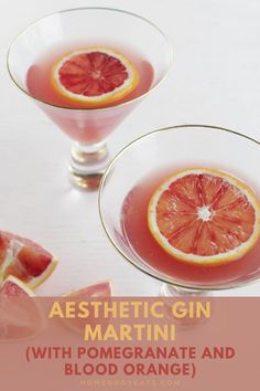 two wine glasses filled with blood oranges on top of a white table next to sliced grapefruit