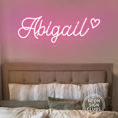 the neon sign above the bed says, abigail on it's side