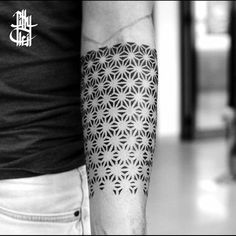 a man with a black and white tattoo on his arm