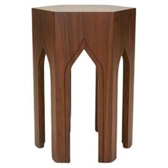 a wooden table with an arch design on the top and bottom section, against a white background