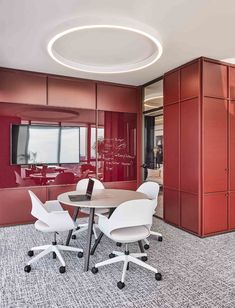 an office with red walls and white chairs