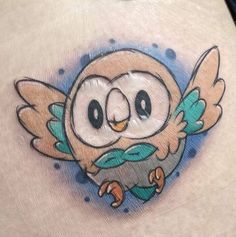 an owl tattoo on the back of a woman's stomach