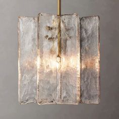 a light that is hanging from a metal pole with some kind of material on it