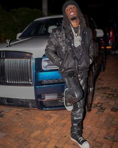 a man standing in front of a car