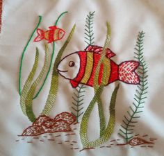 a red fish and green plants on a white cloth