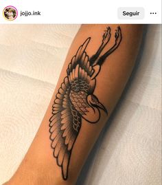 a person with a tattoo on their leg that has an eagle and arrow in it