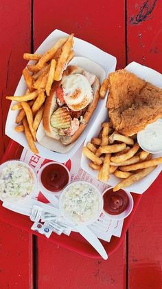 a tray that has some food on it and fries in front of it, with ketchup