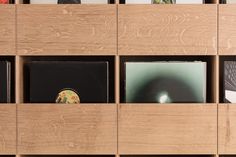 wooden shelves with cd cases and records on them