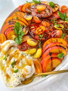 a white plate topped with lots of different types of fruit and vegtables