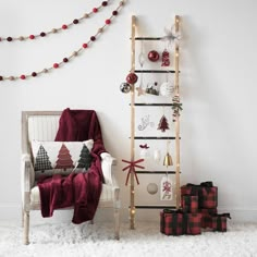 a living room decorated for christmas with presents on the floor and a ladder leaning against the wall