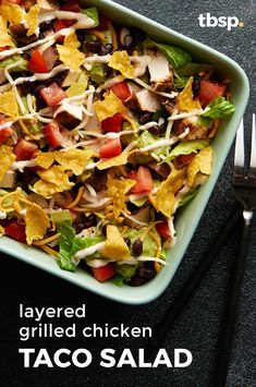 a salad with lettuce, tomatoes and black beans