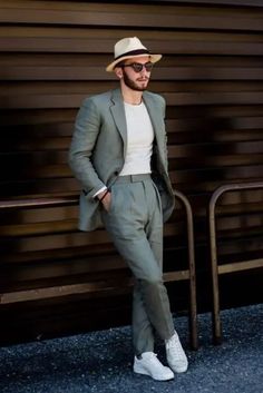 An informal summer wedding guest outfit with a grey pantsuit a white fitting t shirt white sneakers and a hat Men Linen Suits, Mens Beach Wedding Attire, Outfit Poses, Mens Wedding Attire, Western Outfit