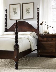 a bedroom with four poster bed, dresser and two framed pictures on the wall above it