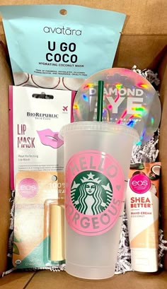 a starbucks drink in a cardboard box with other items