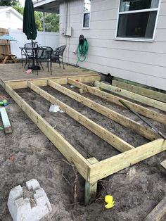 a wooden deck is being built in the sand