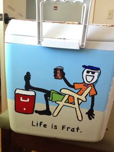 an icebox with a painting of a man sitting on a beach chair