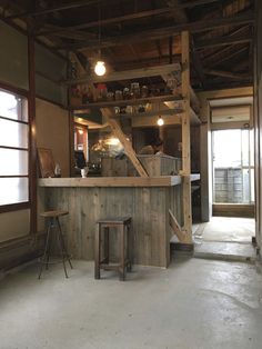 an old fashioned bar with stools in a room that is being used as a restaurant