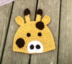 a crocheted hat with a giraffe face on it