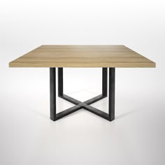 a wooden table with black metal legs and a square top on an isolated white background