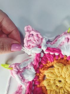 someone is crocheting a flower with yarn