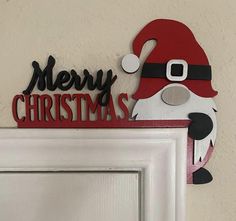 a door hanger that has a santa clause on it