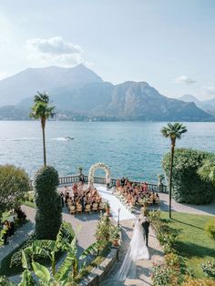 a wedding ceremony on the shores of lake garda with mountains in the back ground