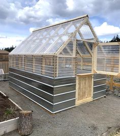 a small greenhouse built into the side of a house