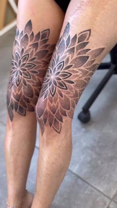 a woman's legs with tattoos on them and her leg in the shape of a flower