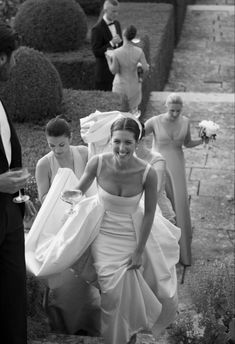 black and white photograph of bride walking down the aisle with her groom in tuxedo