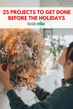 a woman placing lights on a wreath with the words 25 projects to get done before the holidays