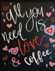 all you need is love and coffee written on a chalkboard with hearts around it