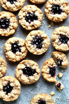 blueberry crumbled cookies are arranged on a sheet of baking paper and ready to be eaten