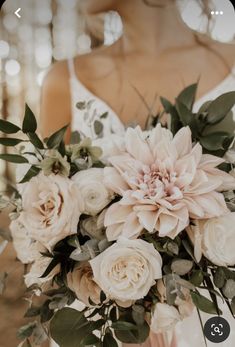 a bride holding a bouquet of flowers in her hands