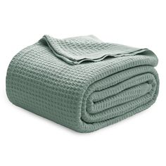 a green blanket folded on top of each other