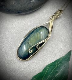 a pendant with a green and blue stone in it