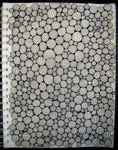 a spiral notebook with black and white designs on it