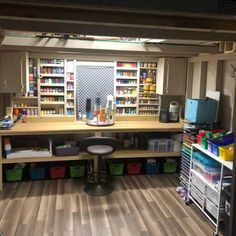 the inside of a craft room with lots of shelves and bins filled with supplies