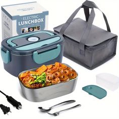 an electric lunchbox with two containers and utensils next to it on a white background