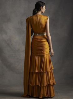 A vibrant pre-stitched layered saree with an embroidered cutwork belt. The saree is paired with a pearl, sequins, tilla & mirror work hand embroidered blouse. The sleeves have pearl & sikka... Drape Lehenga, Bhumika Sharma, Hand Embroidered Blouse, Blouse Yoke, Draping Fashion, Ruffle Saree, Drape Saree, Yellow Saree, Sequin Blouse