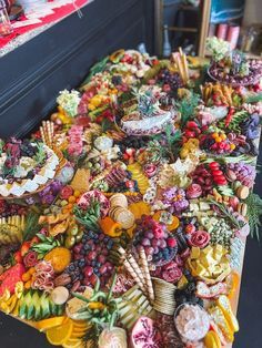 a table covered in lots of different types of candy and candies on it's sides