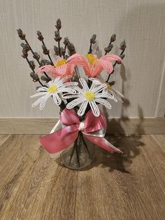 a vase filled with flowers on top of a wooden table