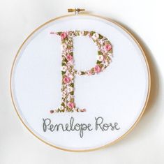 a cross stitch pattern with the letter p in english and floral font, on a white background